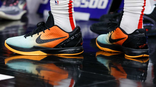 View of black and orange Nike Kobe shoes.